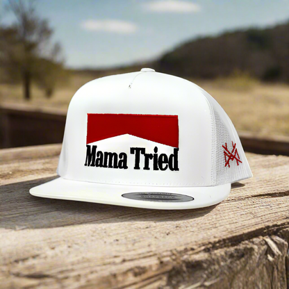 White cap with 'Mama Tried' text and red logo on a white background