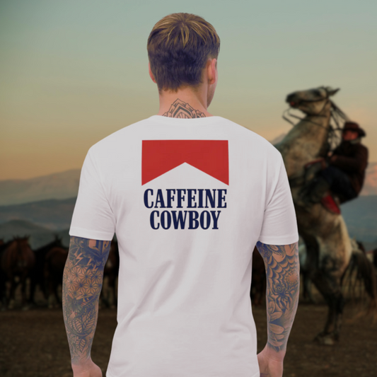 Man wearing a 'Caffeine Cowboy' t-shirt with a horse and rider in the background.