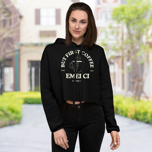 Woman wearing a black hoodie with a coffee-themed design in an outdoor setting